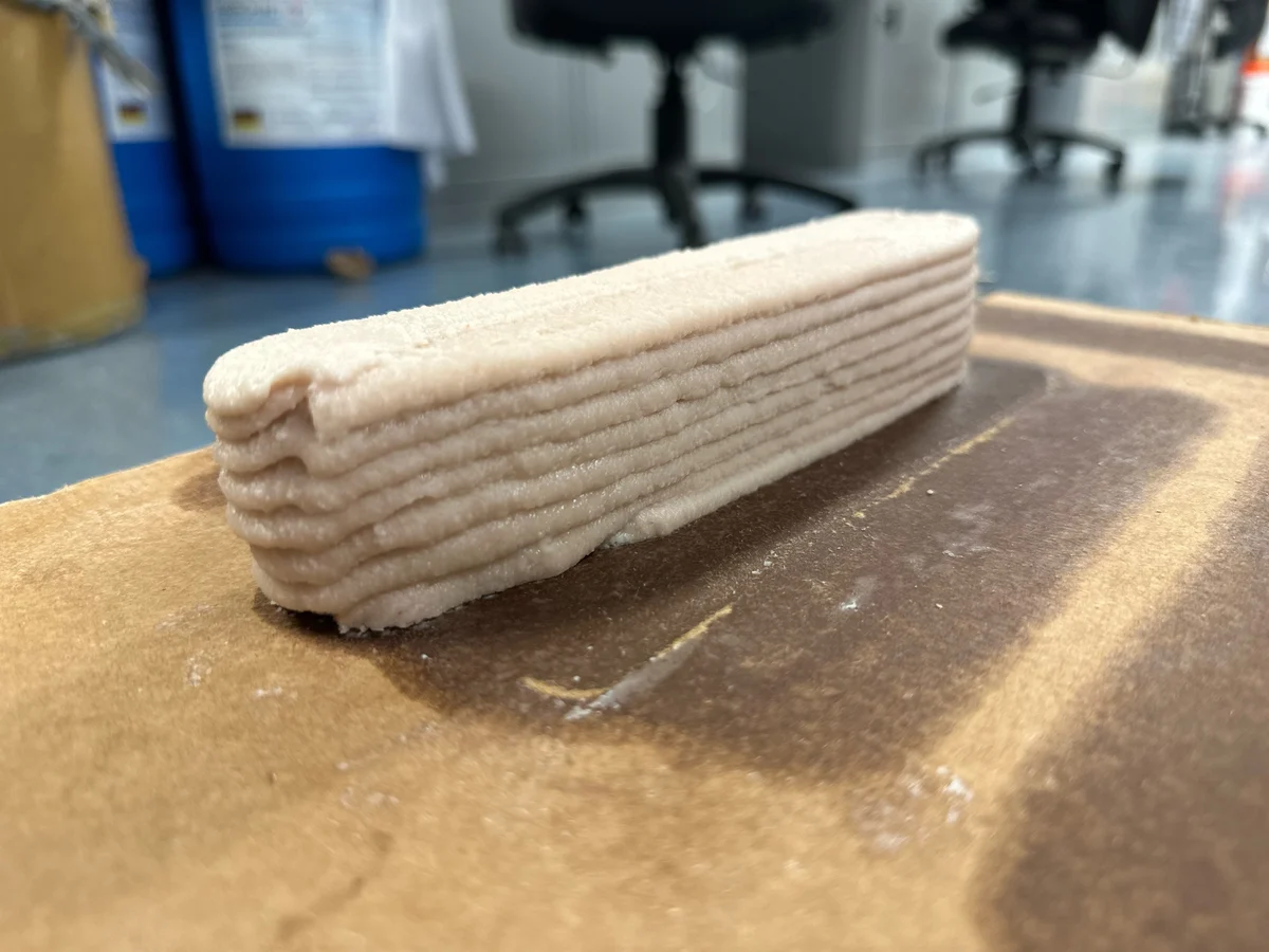 Layered photopolymer composite specimen on the printing platform