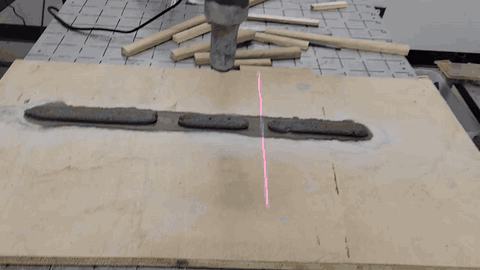 Robot repairing two measured material-loss gaps in a printed mortar layer